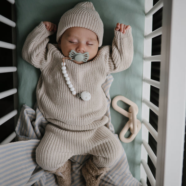 Chunky knit pants for babies, cozy and stylish, shown from a 15-degree angle. Perfect for comfort and warmth.