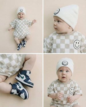Short Sleeve Bubble Romper in Checkered Smiley Latte for babies, showcasing a playful and stylish design.