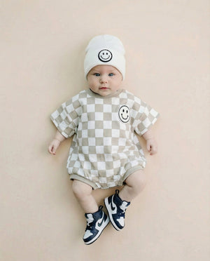 Short Sleeve Bubble Romper in Checkered Smiley Latte for babies - stylish and comfy romper for playful moments.
