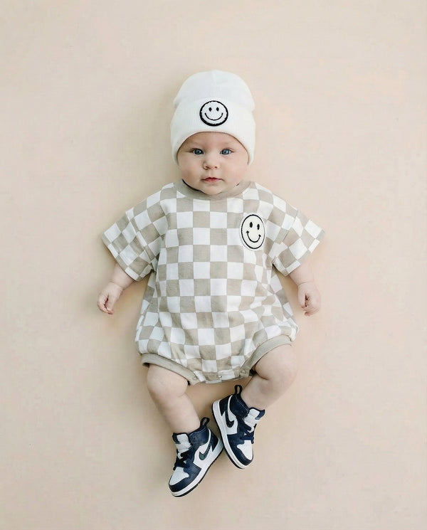 Short Sleeve Bubble Romper in Checkered Smiley Latte for babies - stylish and comfy romper for playful moments.