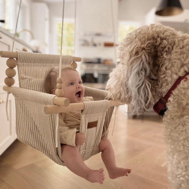 Greige and vanilla striped indoor baby swing, perfect for cozy playtime and relaxation.