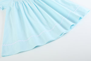 Light blue daisy smocked bishop dress for babies, angle 3 view showcasing delicate design and vibrant colors.