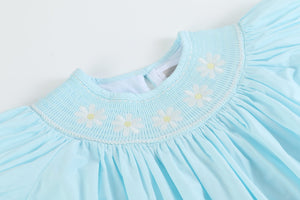 Light blue daisy smocked bishop dress for babies, angle view showcasing delicate design and soft fabric.