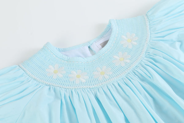 Light blue daisy smocked bishop dress for babies, angle view showcasing delicate design and soft fabric.