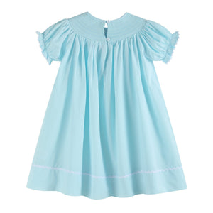 Light blue daisy smocked bishop dress for babies, showcased from angle 2, perfect for special occasions.