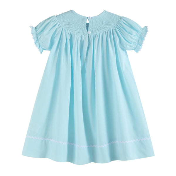 Light blue daisy smocked bishop dress for babies, showcased from angle 2, perfect for special occasions.