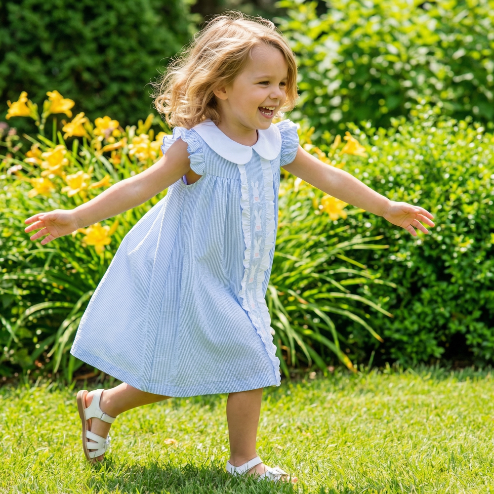 Light blue Easter bunny ruffle yoke dress for babies, perfect for spring celebrations and special occasions.