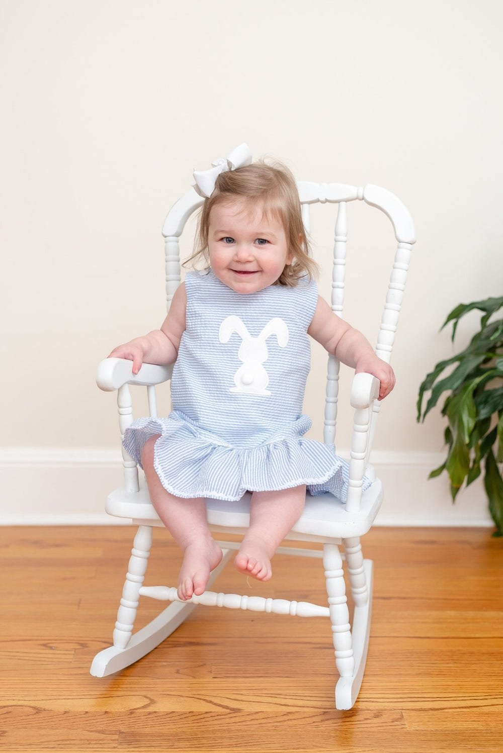 Light blue seersucker pom pom bunny swing dress for babies, perfect for spring and summer outings.