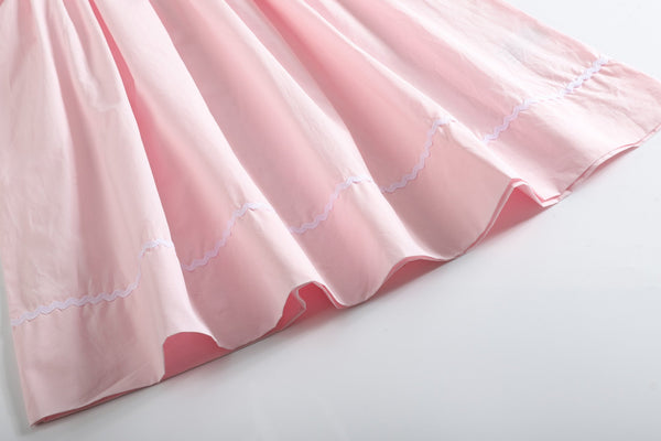 Light pink daisy smocked bishop dress for babies, showcased at angle 3, perfect for special occasions.
