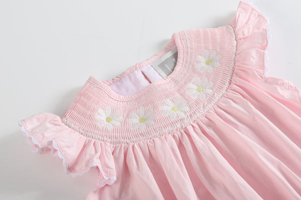 Light pink daisy smocked ruffle romper for babies, angle 3 view showcasing cute design and soft fabric.