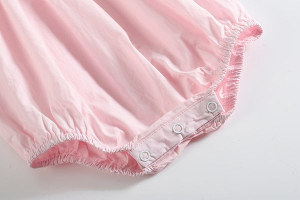 Light pink daisy smocked ruffle romper for babies, shown at angle 4, perfect for stylish summer outfits.