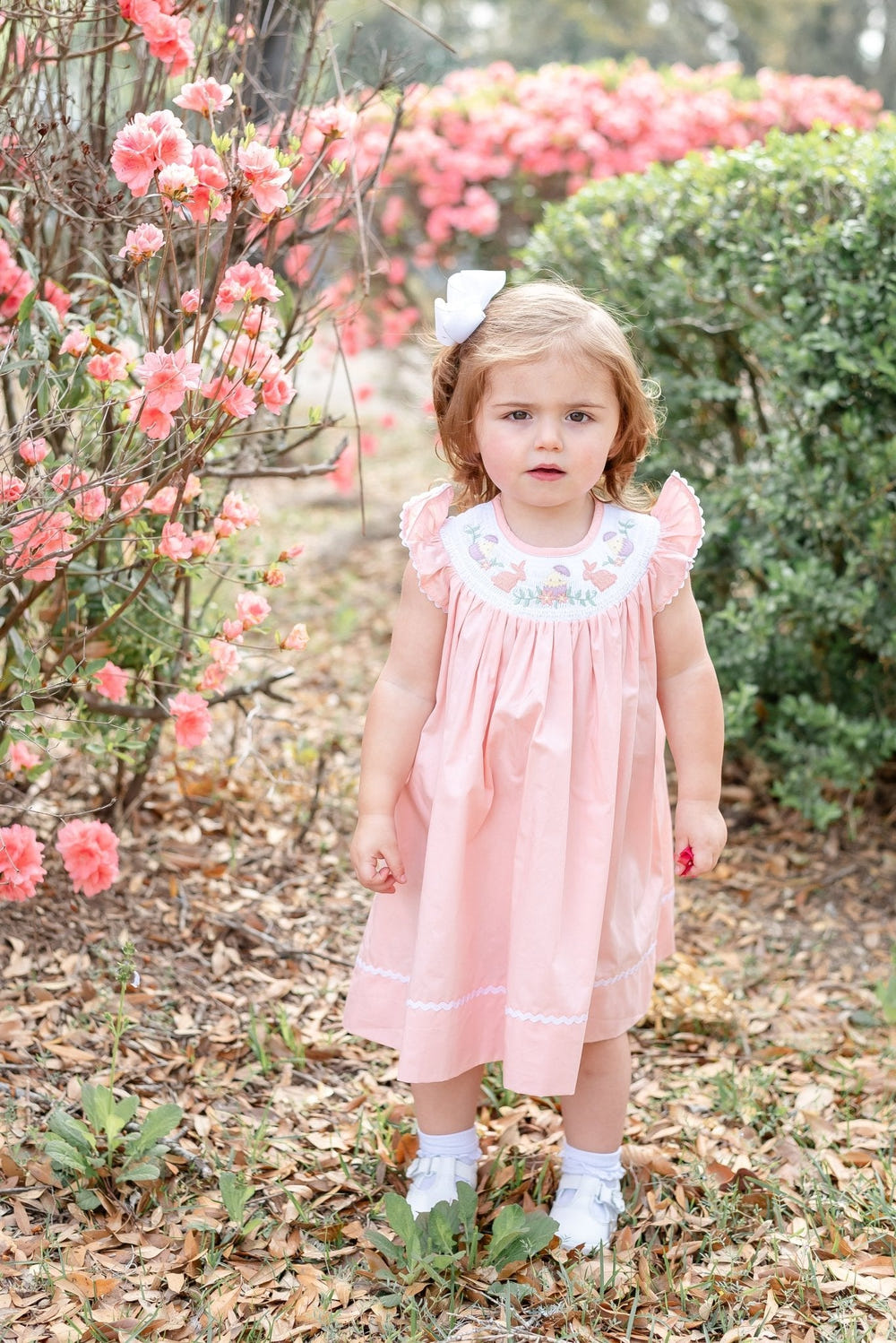Light pink Easter smocked bishop dress for babies, perfect for spring celebrations and seasonal wear.