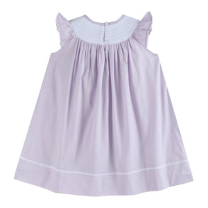 Light purple bunnies smocked bishop dress for babies, angle view showcasing cute design and details.