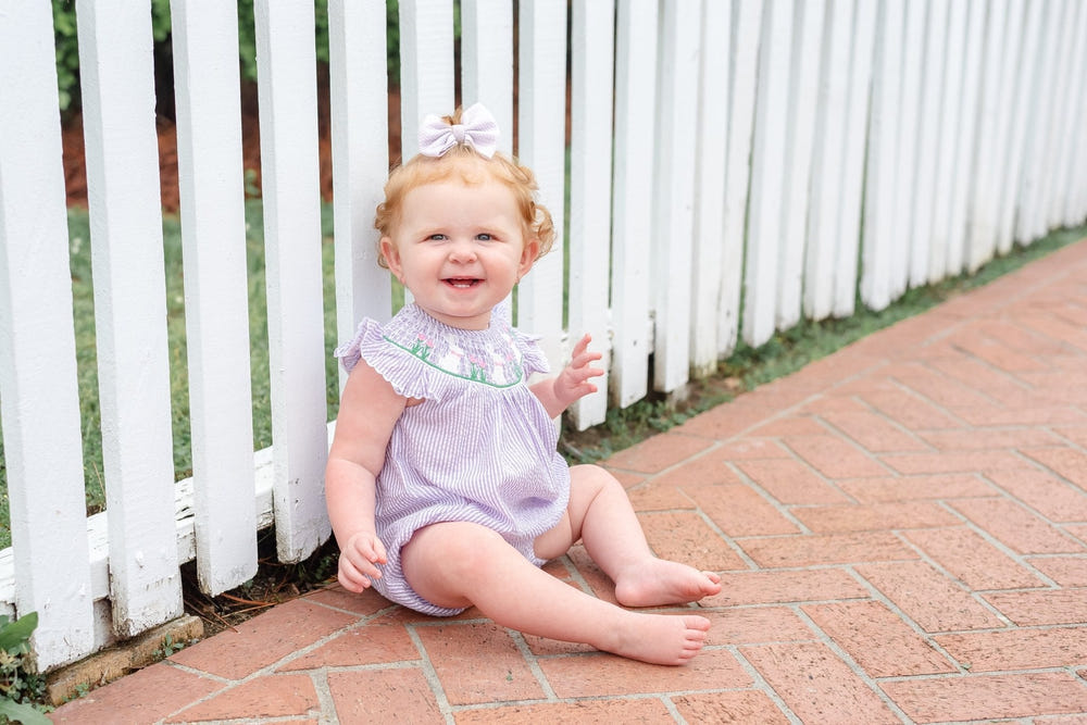 Light purple seersucker bunny smocked romper for babies, perfect for stylish and comfortable playtime.
