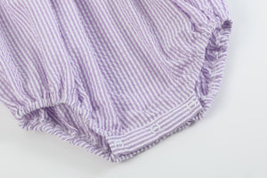 Light purple seersucker bunny smocked romper for babies, shown from angle 2, perfect for spring outfits.