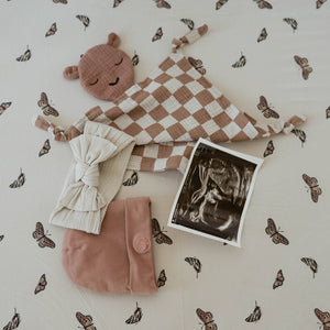 100% Muslin Lovey in Rosewood Checker pattern, soft and cuddly for babies, angle view showcasing its design.