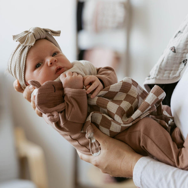 100% Muslin Lovey in Rosewood Checker pattern, soft and cozy for babies, angle view showcasing its design and texture.