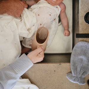 Colorful bath rinse cup for babies, angled view showcasing ergonomic design and easy grip for bath time fun.