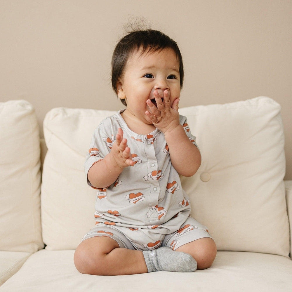 Mama Tattoo Hearts Bamboo Henley Romper for babies, stylish and comfortable clothing in soft bamboo fabric.