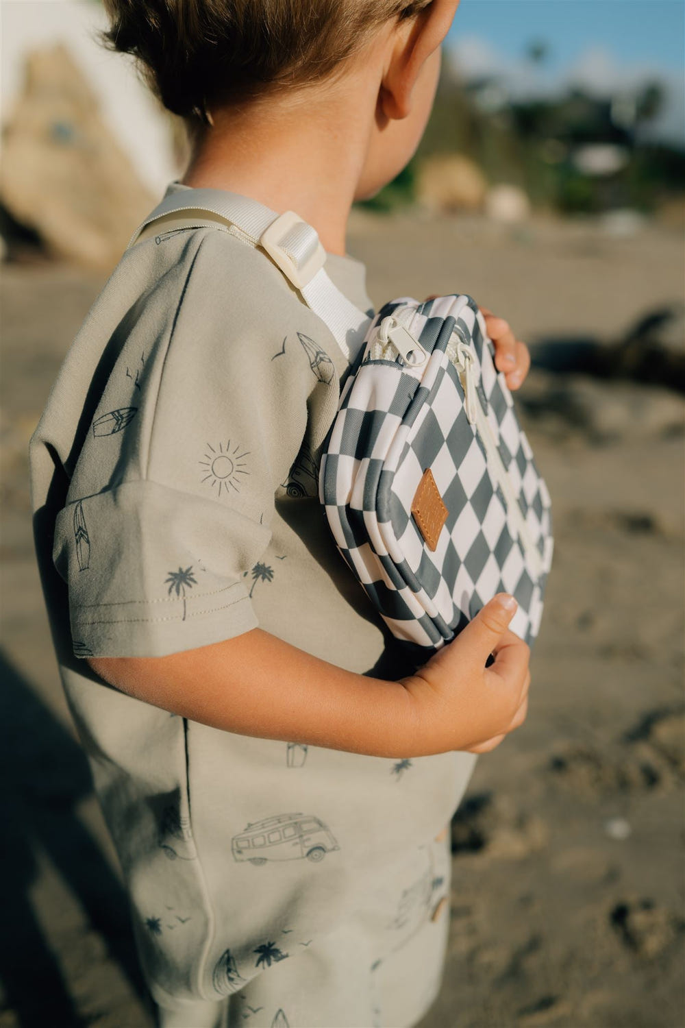 Green checkered mini fanny pack for babies, perfect accessory for outings and seasonal wear.