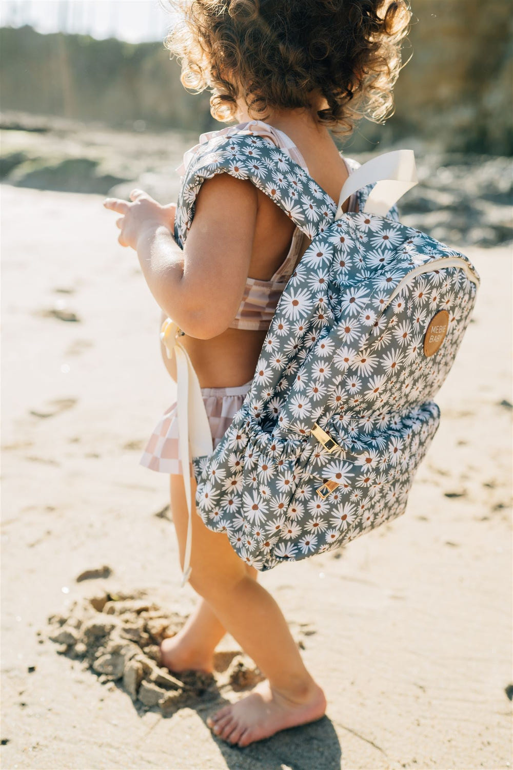 Green Daisy Mini Backpack for babies, perfect accessory for outings and seasonal adventures.