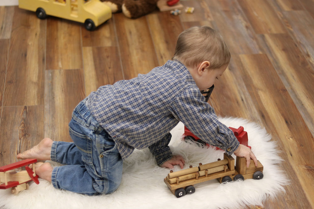 Amish-made wooden log semi truck toy with removable logs, perfect for imaginative play.