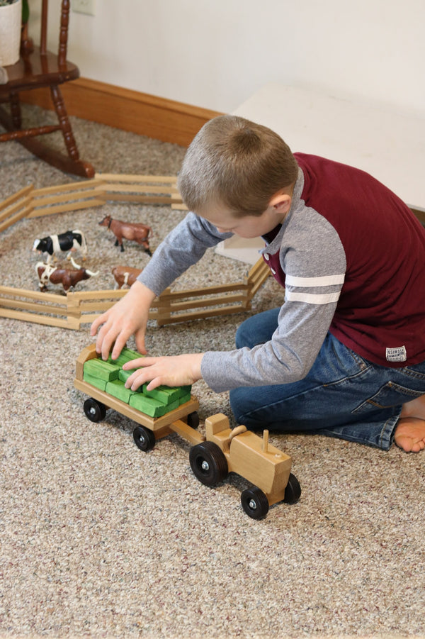 Amish-made wooden toy tractor and wagon set with hay bales, perfect for imaginative play. Angle 6 view.