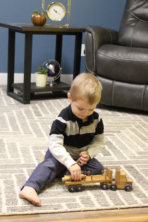 Amish-made wooden log semi truck toy with removable logs, perfect for imaginative play.