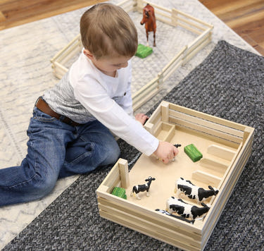 Amish-made wooden mini stockyard toy with 7 stalls, perfect for imaginative farming play.
