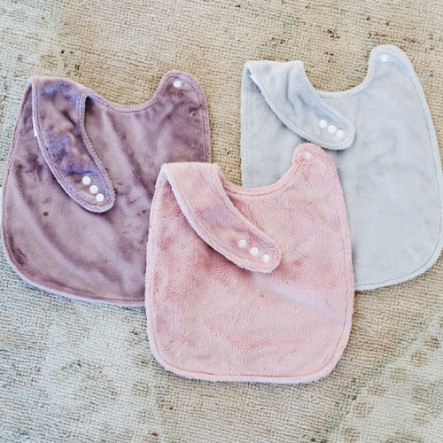 Minky Bibs 3-Pack for babies, featuring soft, absorbent fabric in various colors, shown from angle 2.