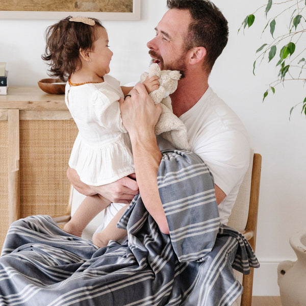 Minky stretch receiving blankets in soft colors, angled view showcasing texture and versatility for newborns.