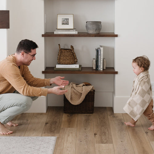 Minky stretch receiving blankets in soft colors, perfect for swaddling and keeping babies cozy. Angle view.