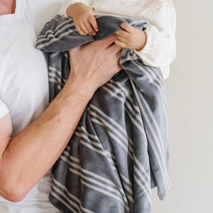 Soft Minky Stretch Receiving Blankets in various colors, perfect for swaddling and keeping your baby cozy.