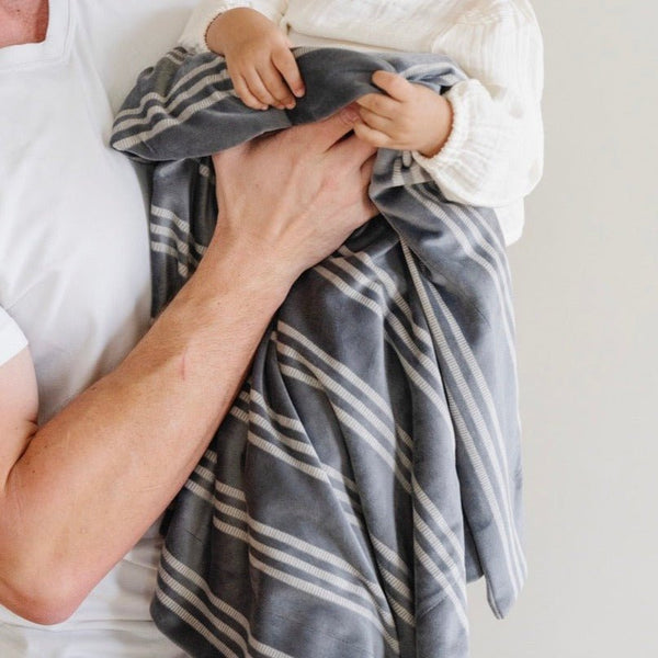 Soft Minky Stretch Receiving Blankets in various colors, perfect for swaddling and keeping your baby cozy.