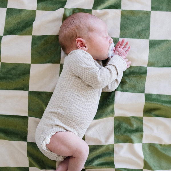Soft Minky Stretch Receiving Blankets in various colors, perfect for swaddling and keeping your baby cozy.