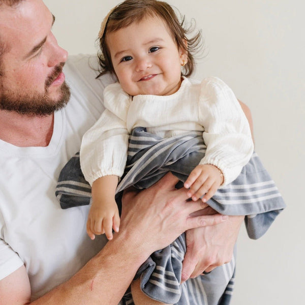 Minky stretch receiving blankets in soft colors, perfect for swaddling and keeping your baby cozy.