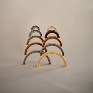Colorful Rainbow Stacker Toy for babies, featuring vibrant rings in a playful design, angled view showcasing its fun shape.