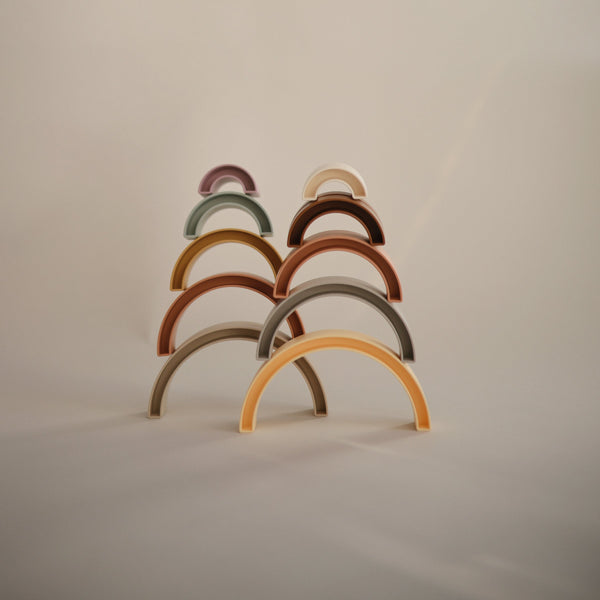 Colorful Rainbow Stacker Toy for babies, featuring vibrant rings in a playful design, angled view showcasing its fun shape.