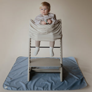Long sleeve bib for babies, featuring a colorful design, angled view showcasing its protective coverage and comfort.
