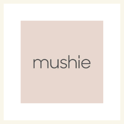 Mushie logo on a light pink background