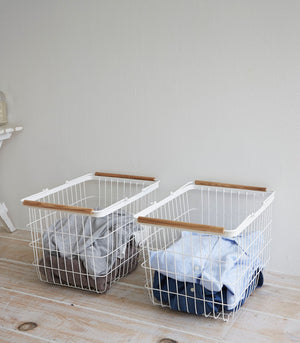 Stylish steel and wood wire laundry basket in two sizes, angled view showcasing design and functionality.