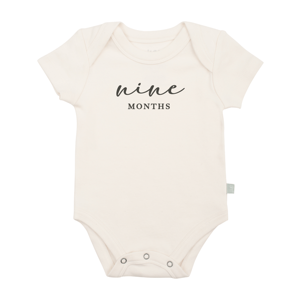 Charcoal graphic bodysuit for nine months milestone, short sleeve design for baby comfort and style.
