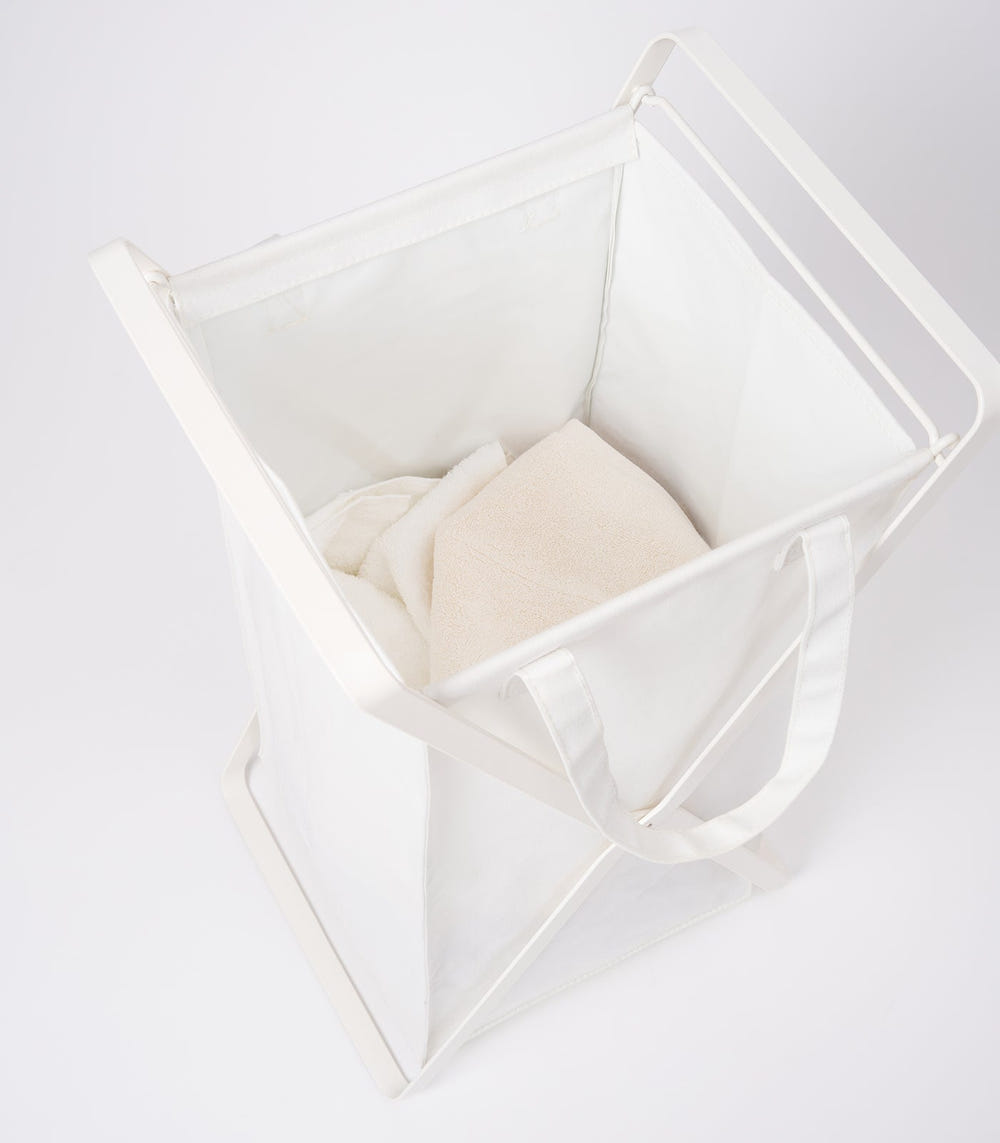 Laundry hamper with cotton liner in two sizes, made of steel and cotton, ideal for organizing baby laundry.