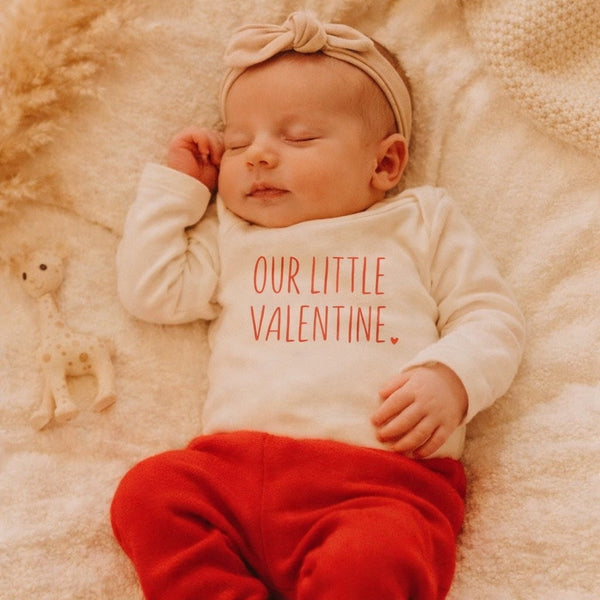 Long sleeve graphic bodysuit for babies by Little Valentine, shown at angle 3. Perfect for stylish and cozy outfits.