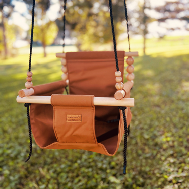 Premium Outdoor High Back Swing in Nutmeg color, perfect for babies and toddlers, offering comfort and safety.