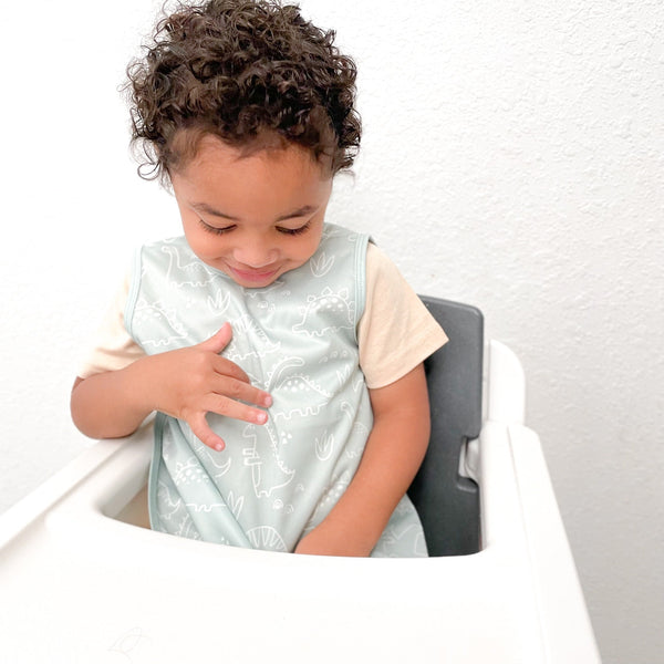 Dino Friends Sage Bapron for preschoolers on sale, angled view showcasing fun dinosaur design.