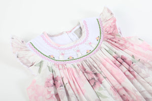 Pink and white peony bunny smocked bishop dress for babies, shown from angle 3.