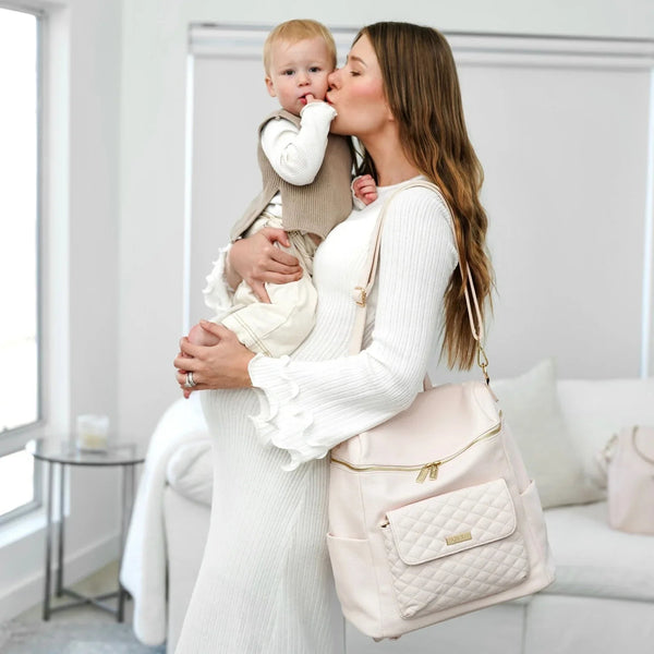 Pastel pink signature diaper bag at angle 11, stylish and functional for modern parents.