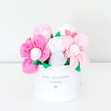 Petite pink hatbox bouquet featuring delicate flowers, perfect for gifting or home decor.