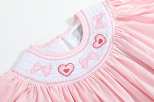 Pink Hearts & Bows Smocked Bishop Dress for babies, shown from angle 3, featuring a charming design and soft fabric.
